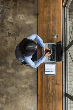 Young woman using smartphone for work Stock Photos