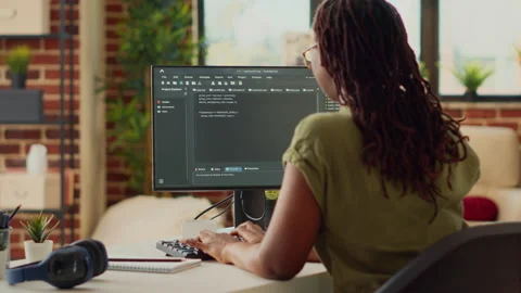 Young woman using source code to develop new online app Stock Footage 222740072