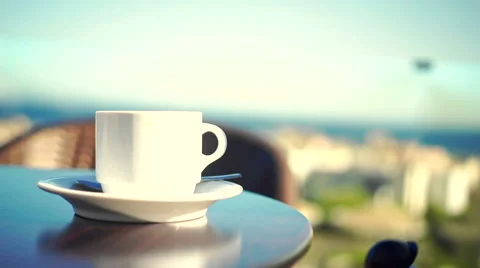 Young woman using tablet and drinking coffee outside on sunny morning. Video stock 58278795