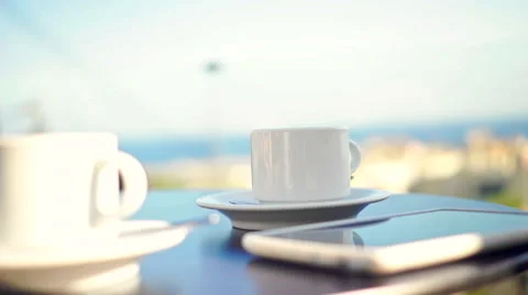 Young woman using tablet and drinking coffee outside on sunny morning. Stock Footage 58279095