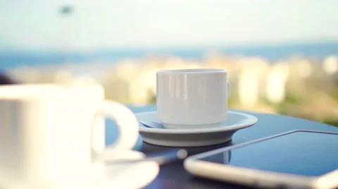 Young woman using tablet and drinking coffee outside on sunny morning. Stock-Footage 58279267