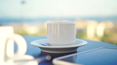 Young woman using tablet and drinking coffee outside on sunny morning. Stock Footage 58279293