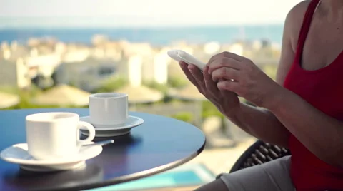 Young woman using tablet and drinking coffee outside on sunny morning. Stock Footage 58279692