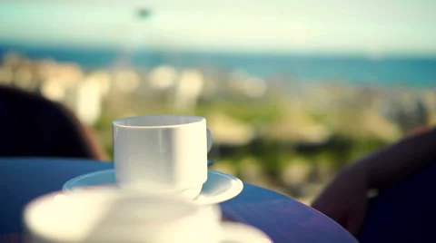 Young woman using tablet and drinking coffee outside on sunny morning. Stock Footage 58279773