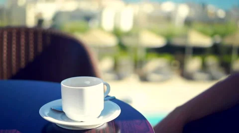 Young woman using tablet and drinking coffee outside on sunny morning. Stock Footage 58279805
