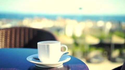 Young woman using tablet and drinking coffee outside on sunny morning. Video stock 58279982