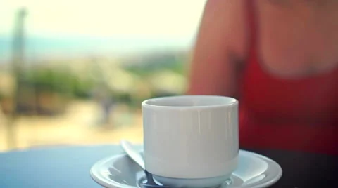 Young woman using tablet and drinking coffee outside on sunny morning. Stock-Footage 58280025