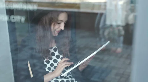 Young woman using tablet in coffee shop Stock Footage 64915526