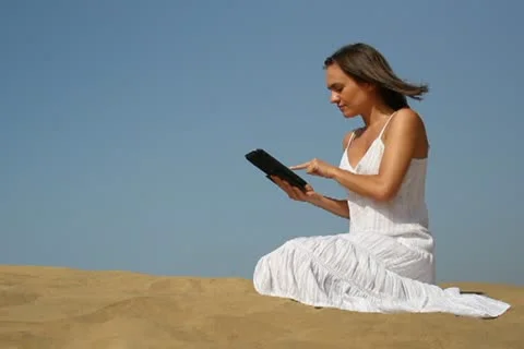 Young woman using tablet computer on the beach NTSC Stock Footage 10902031