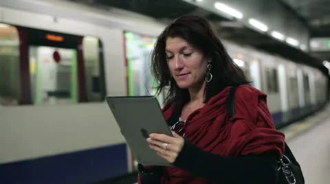 Young woman using tablet computer on metro station HD Stock-Footage 11469774