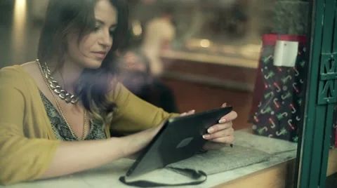 Young woman using tablet computer in cafe, steadicam shot HD Stock Footage 18011477
