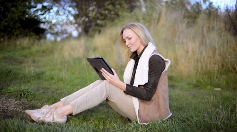 Young woman using tablet computer outside Video stock 55386000