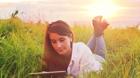 Young Woman Using Tablet Computer Touchscreen. Beautiful Vintage Sun Flare Ou Stock Footage 56026247