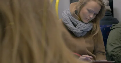 Young woman using tablet computer in subway train Video stock 57368342