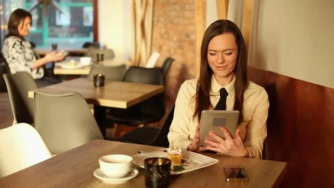 Young woman using tablet computer in cafe Video stock 72319507