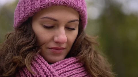 Young woman using tablet computer while sitting on bench in autumn park. Close Stock Footage 82837326