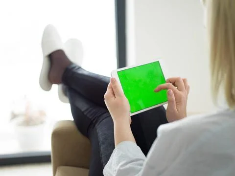 Young woman using tablet computer in front of fireplace beautiful young wo... Stock Photos