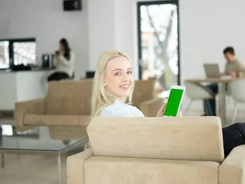 Young woman using tablet computer in front of fireplace beautiful young wo... Stock Photos