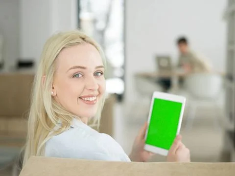 Young woman using tablet computer in front of fireplace beautiful young wo... Stock Photos