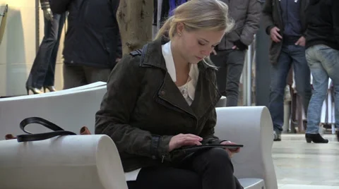 Young woman using tablet in public Stock Footage 33736449