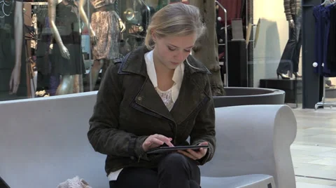 Young woman using tablet in shopping mall Stock Footage 33736472