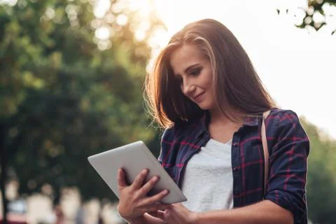 Young woman using a tablet while out in the city Stock Photos