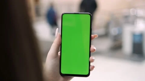 Young Woman Using Touch Screen Mobile Phone. Girl Using Smartphone, Browsing Video stock 194413569