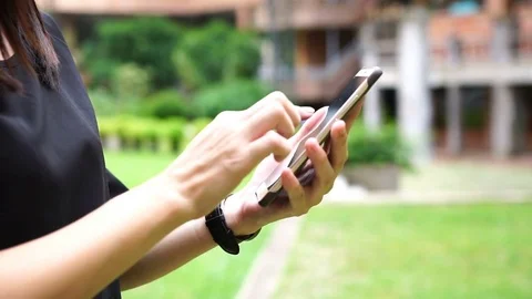 Young woman using touchscreen mobile phone. Stock Footage 78774275