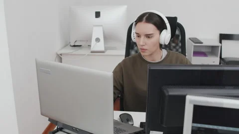Young Woman Using Two Computers At Work Stock Footage 232671616