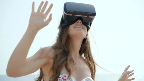 Young woman using virtual reality glasses outdoors in summer time. Slow motion Stock-Footage 92553024