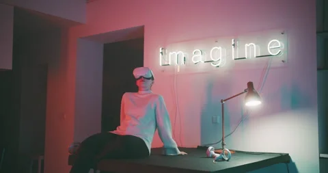 Young woman using virtual reality glasses in her studio Stock Footage 201130976