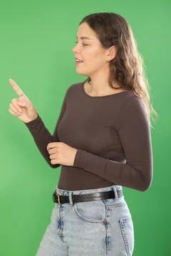Young woman using virtual screen in front of green screen Stock Photos