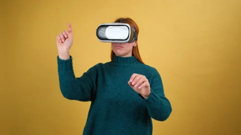 Young woman using VR app headset helmet. Slide gestures. Watching virtual Stock Footage 148678719