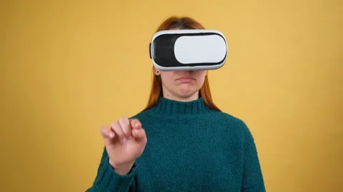 Young woman using VR app headset helmet. Slide gestures. Watching virtual Stock Footage 150054750