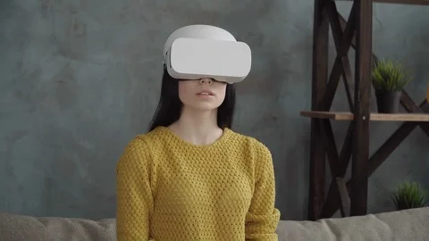 Young woman is using a vr head-mounted display in the room Stock Footage 74954147
