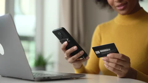 Young woman using wireless devices and credit card for online shopping in home Stock Footage 171098096
