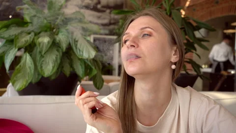 Young Woman Vaping E-Cigarette in Cafe Slow Motion Stock Footage 330102652