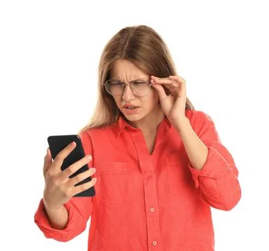 Young woman with vision problems using smartphone on white background Stock Photos
