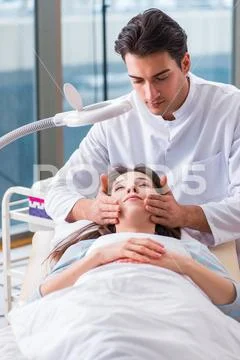 Young woman visiting male doctor cosmetologist Stock Photos