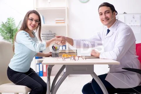 Young woman visiting male doctor oculist Stock Photos