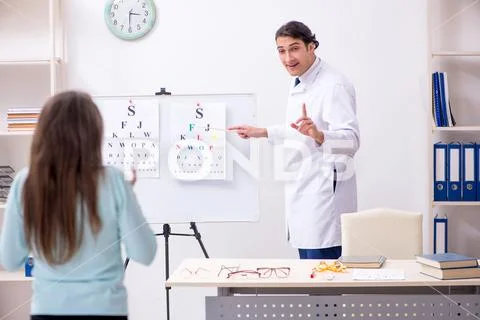 Young woman visiting male doctor oculist Stock Photos