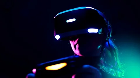 Young woman in VR headset using gamepad have fun and play interactive video game Stock Footage 87885637