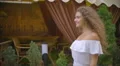 The young woman walk along the restaurant terrace. Slow motion. Wide angle 4k or 4k+ Resolution