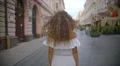 The young woman walk on the street. Slow motion. Wide angle 4k or 4k+ Resolution