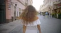 The young woman walk on the street. Slow motion. Wide angle 4k or 4k+ Resolution