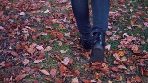 Young woman walking in the autumn Park. female feet closeup. girl walking on Stock Footage