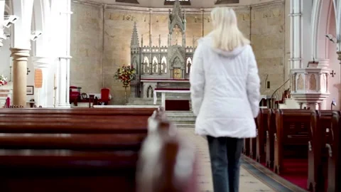 Young Woman Walking Down Empty Church Isle 스톡 동영상 193143230