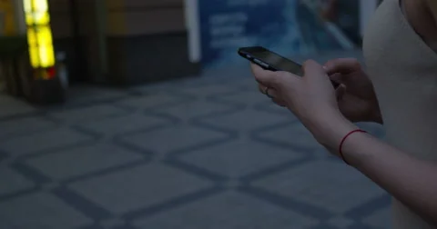 Young woman walking hands using smartphone to text message Stock Footage 66432090