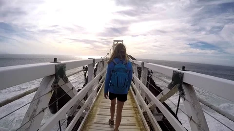 Young woman walking to Lighthouse Stock Footage 79588192