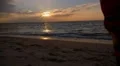 Young Woman Walking on Seacoast in Long Summer Dress at Sunset. Slow Motion. HD Footage